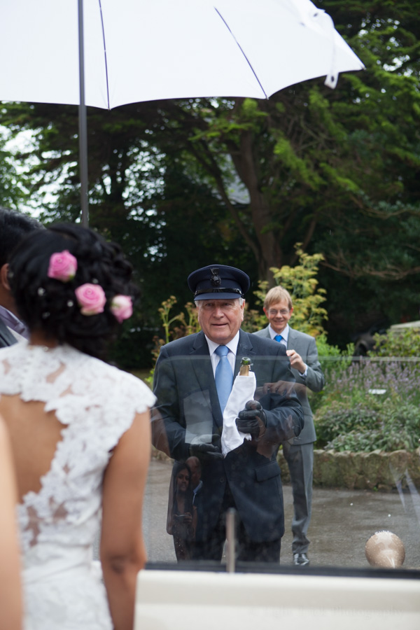 chauffeur waiting with bottle of champagne